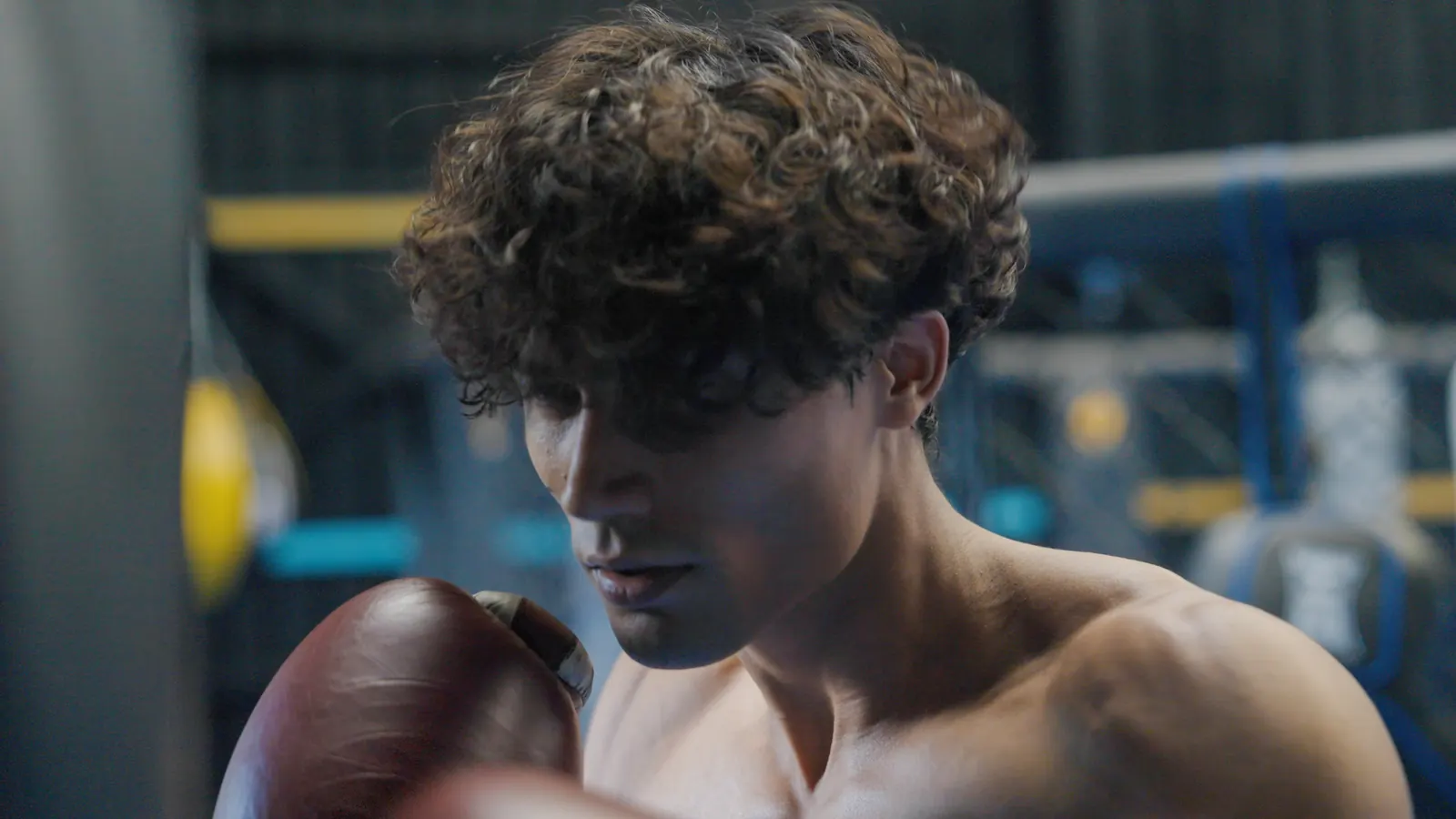 Fighter in boxing gloves focused during a training session