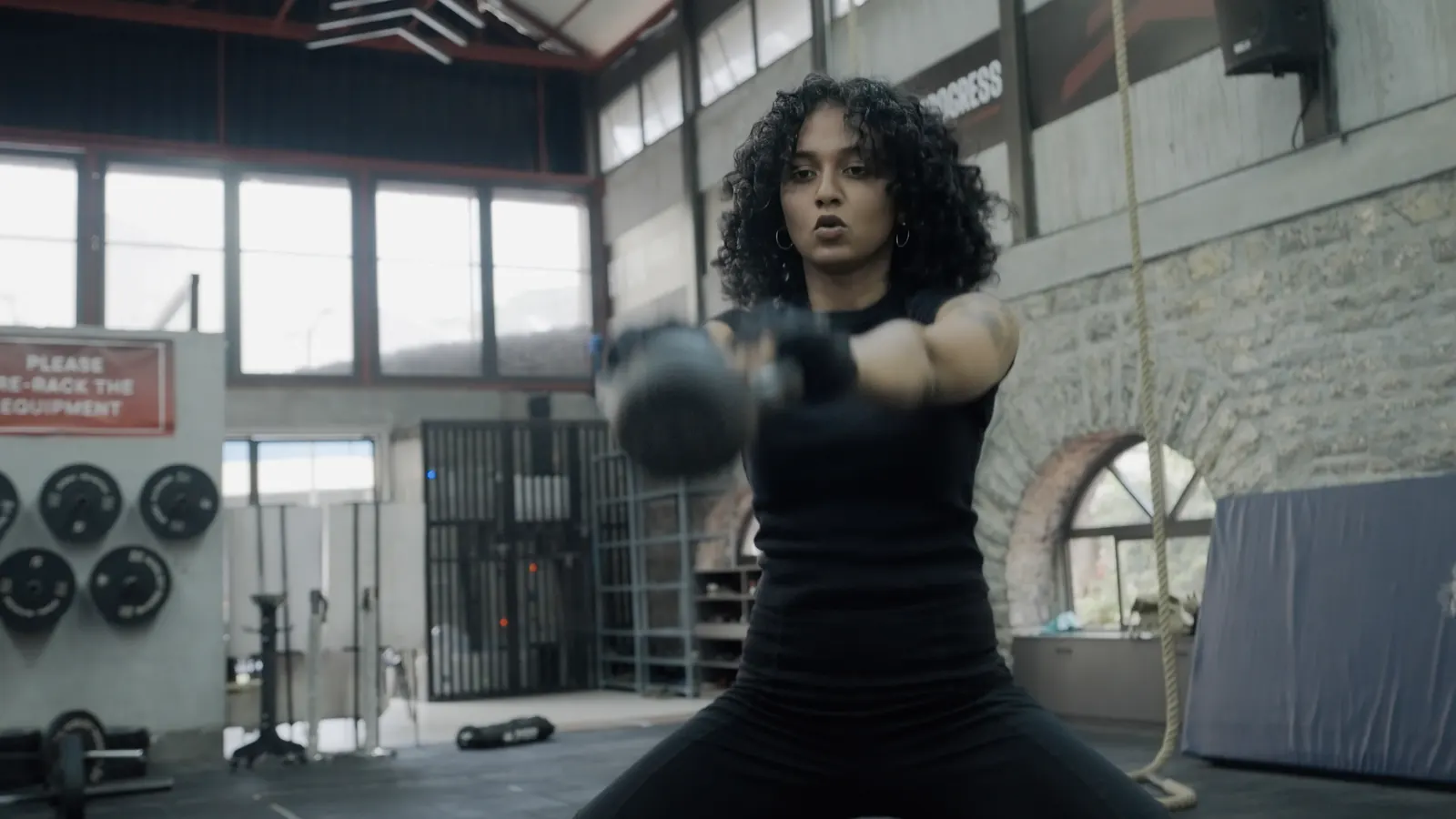 Athlete swinging a kettlebell in the EvoQuest training space