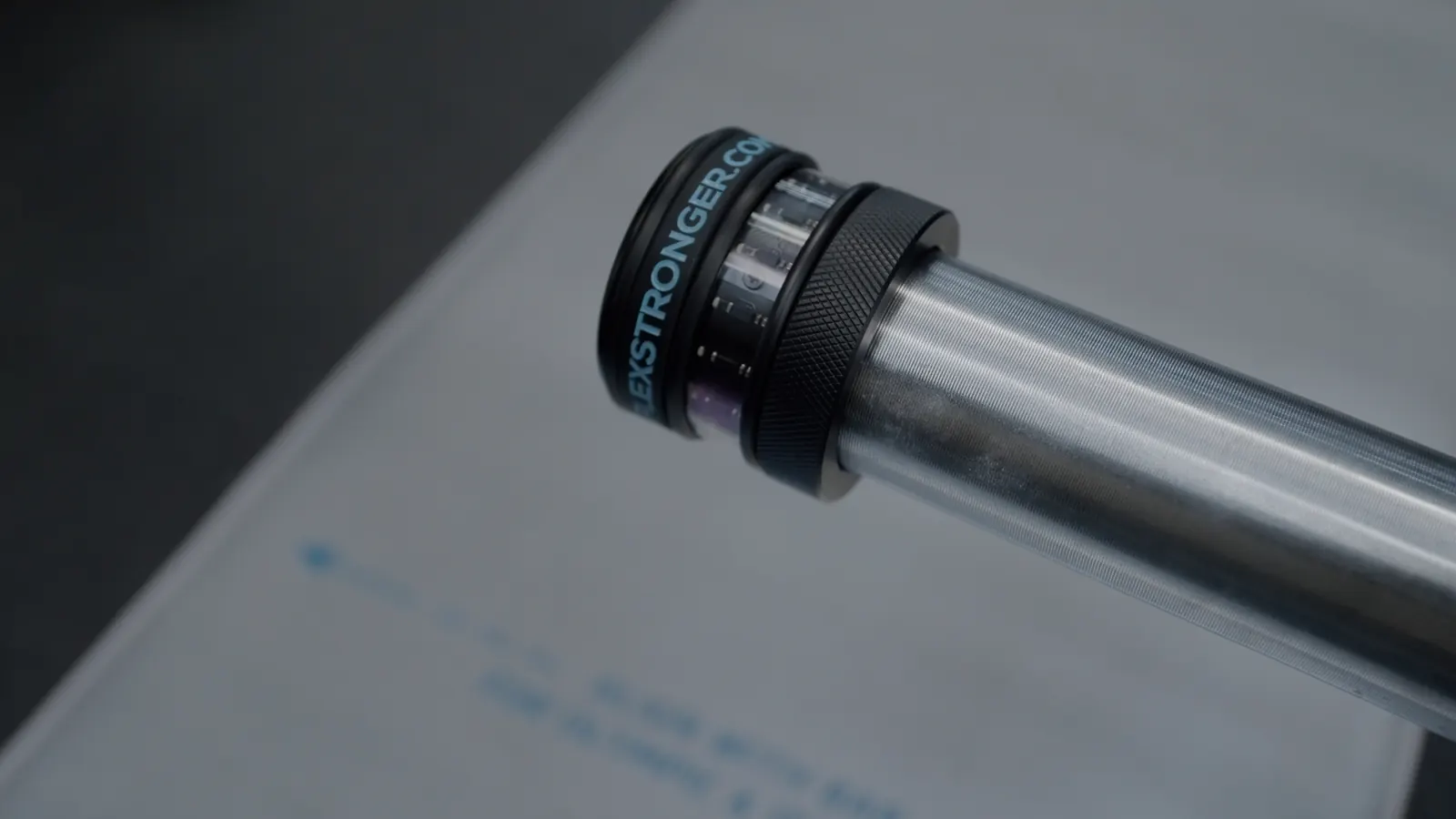 Velocity sensor mounted on the end of a barbell